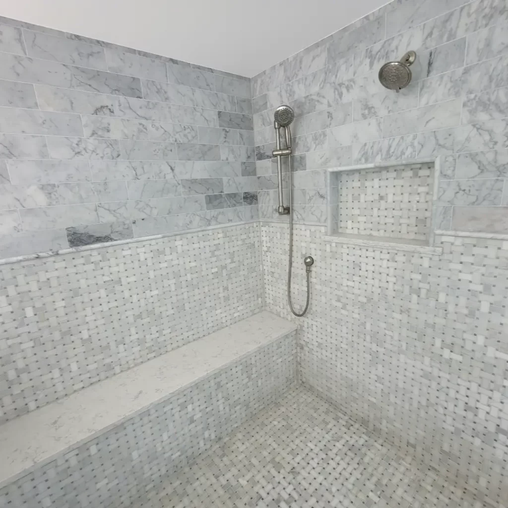 Bathroom Renovations. Elegant marble shower with seating area.