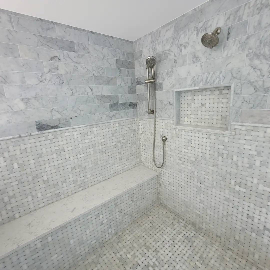Bathroom Renovations. Elegant marble shower with seating area.
