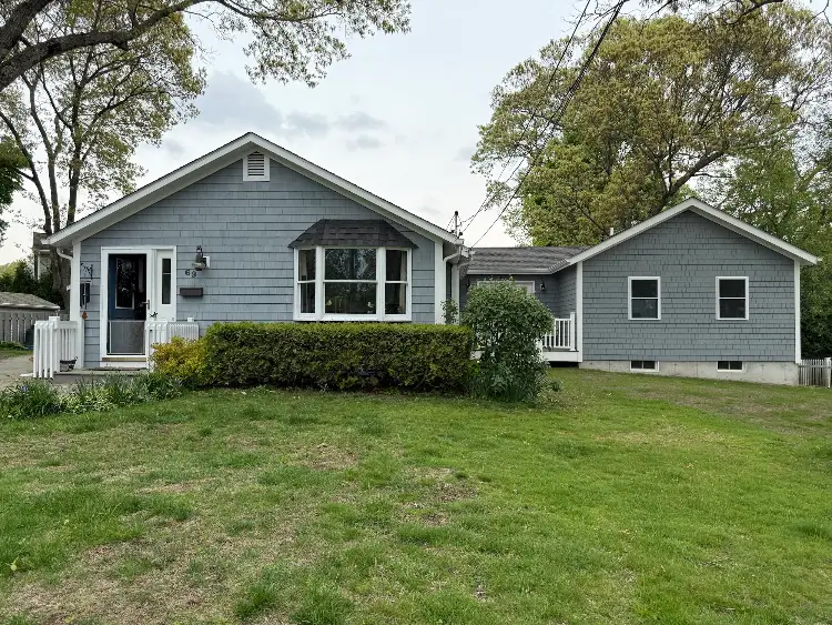 Gray Rhode Island home with an attached in-law suite addition on the side, built by JB Cote Construction